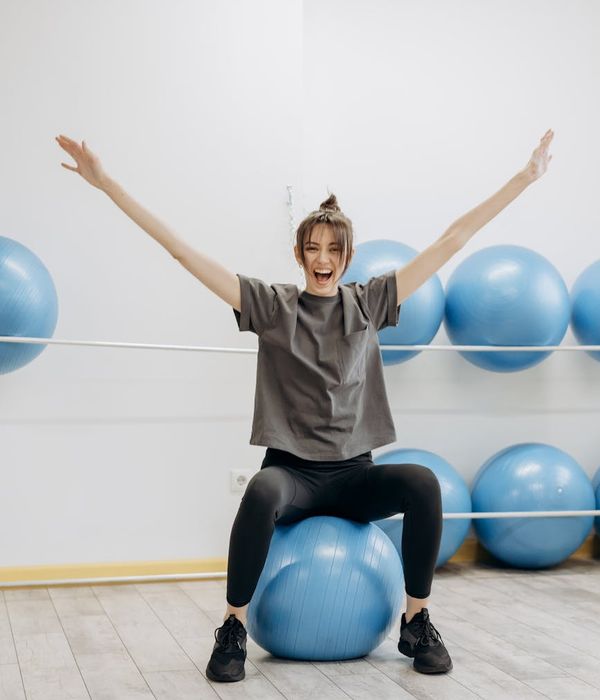 Woman feeling energetic and balanced in a bright room.